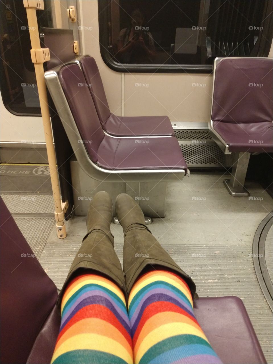Rainbow socks riding on the Max lightrail train in Portland, OR.