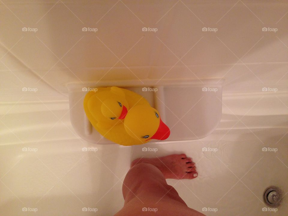 From where I stand in bathtub having shower yellow rubber duck