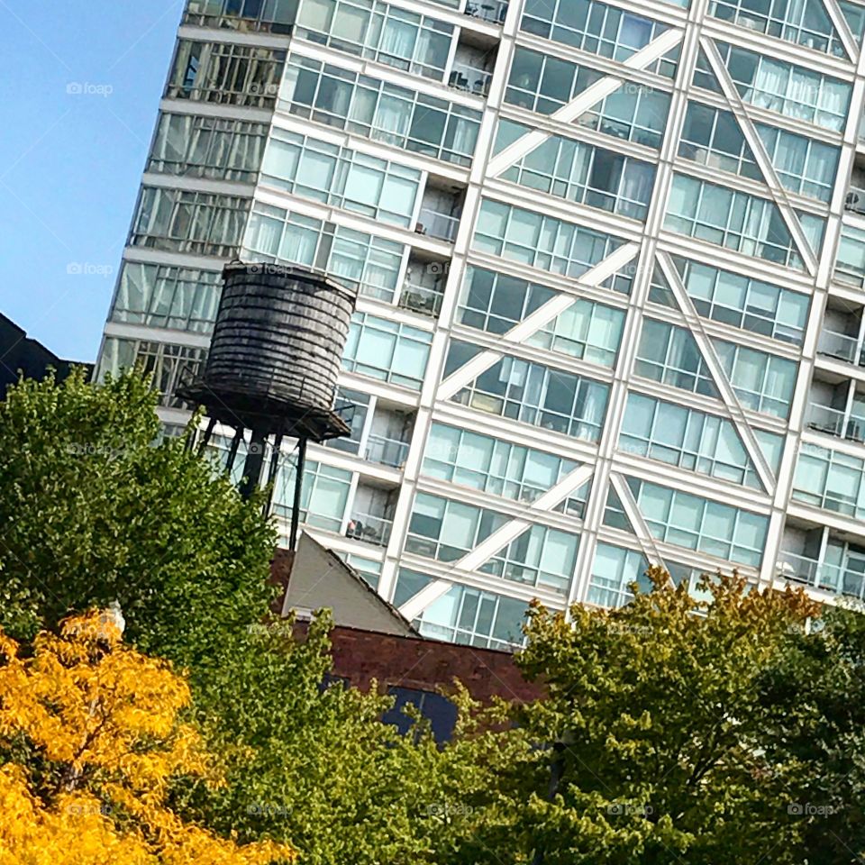 Water tower by glass building 