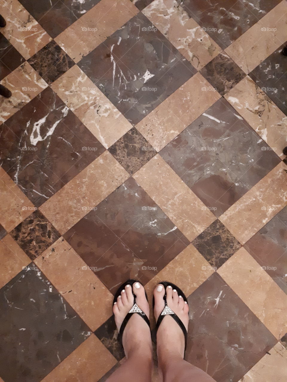 Woman's feet on the tile floor