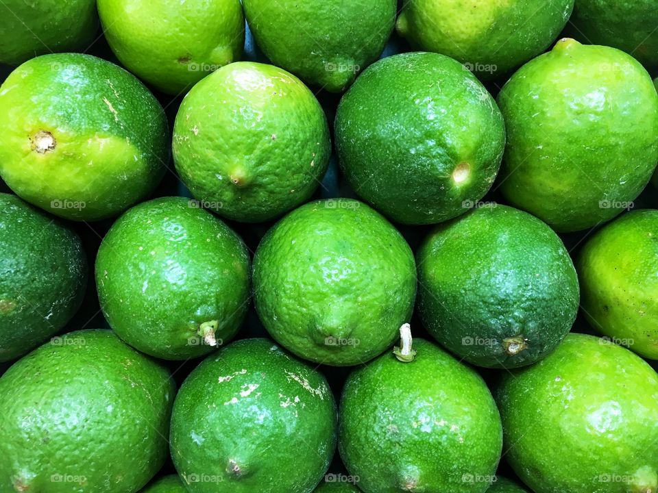Group of Organic Green Limes Displayed at Market