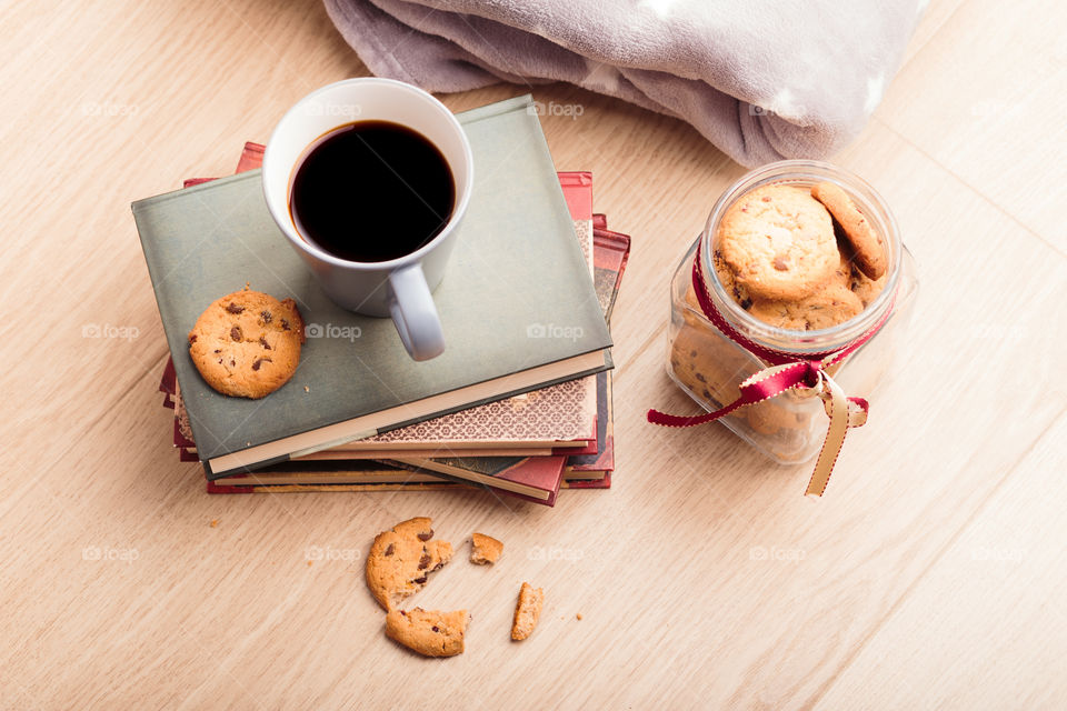 A few books with cup of coffee and cookies on wooden floor. Time for relax. Spending leisure time on reading. Cozy and comfortable. Relaxing 😌