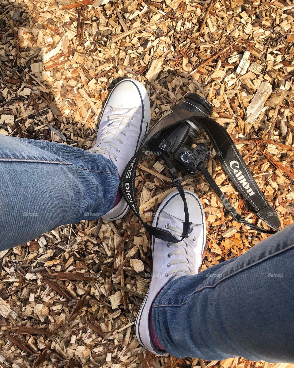 My feet. Captured on a down period during a photo shoot, my canon SLR camera is shown next to my feet 