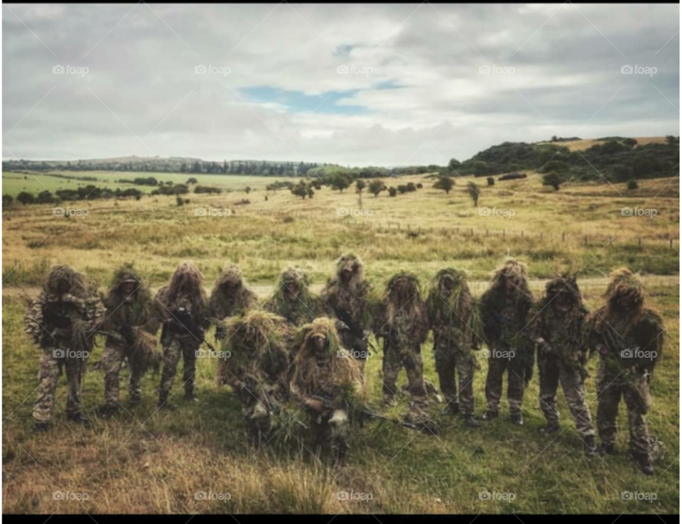 An RAF Regiment sniper section on an exercise in Kirkcudbright, Scotland. All wearing handmade Ghillie suits in order to blend into the background.