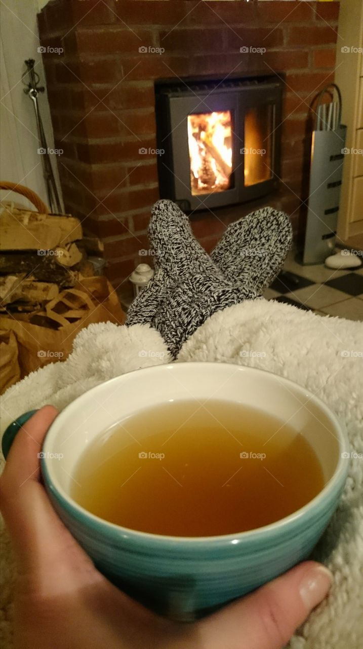 A cup of tea in front of the fireplace