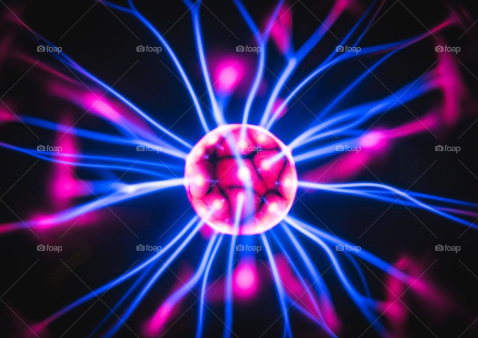 Beautiful abstract background of an electric discharge with blue, oblique and pink lightning in a night lamp, close-up side view. The concept of backgrounds, texture, technology.