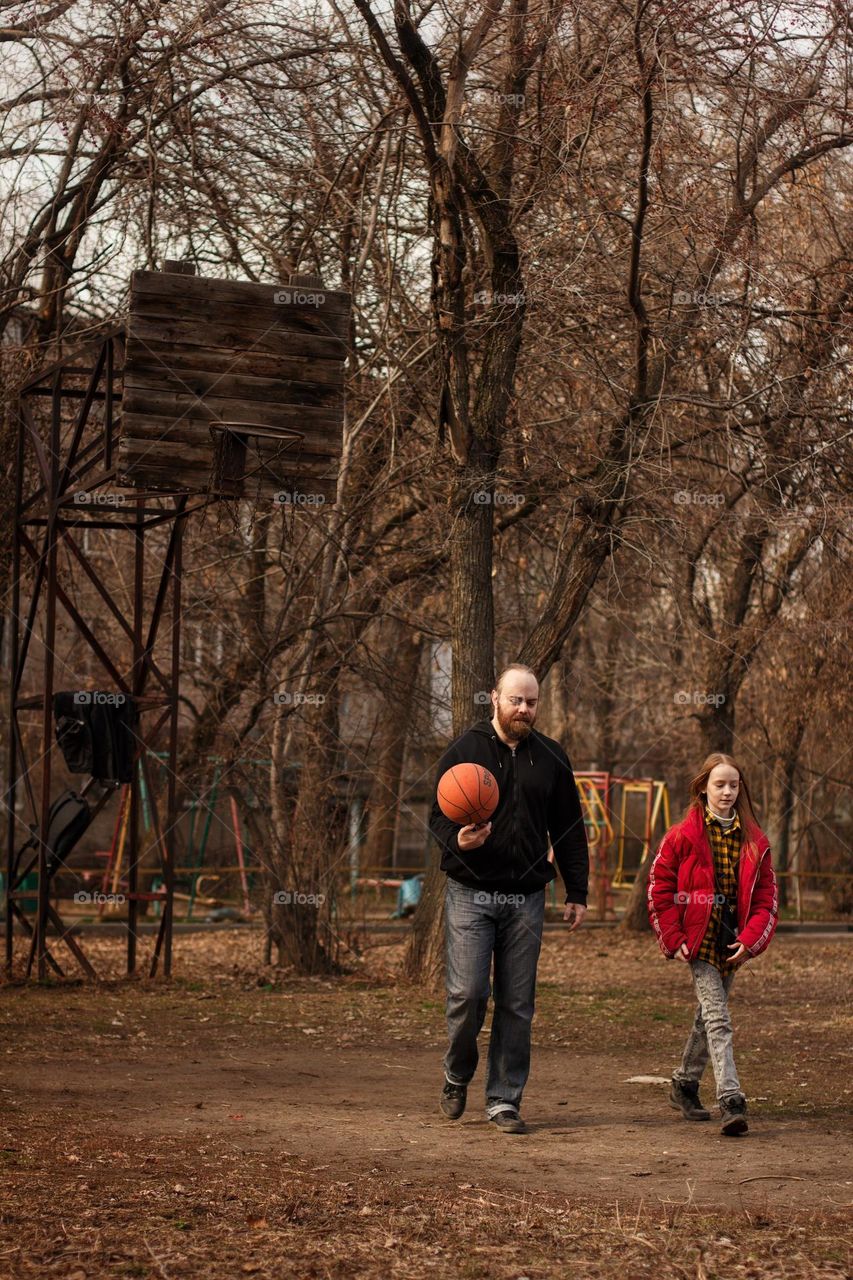 Father and daughter playing basketball