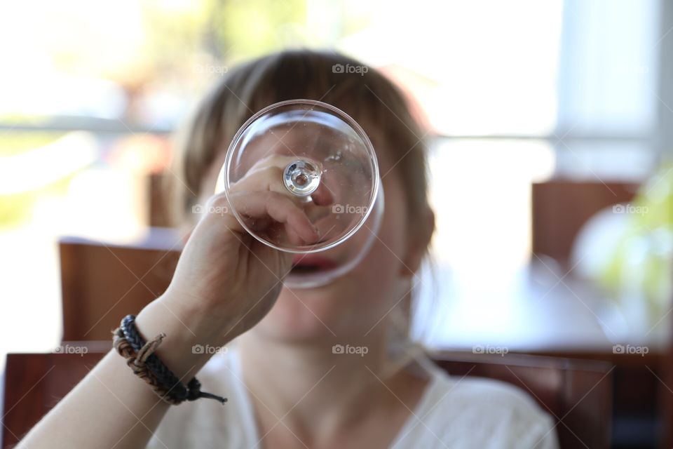 Girl drinking from a wineglass 