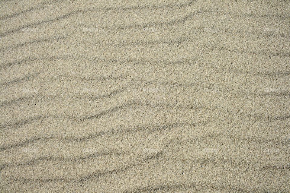 Sunny rippled sand beach texture