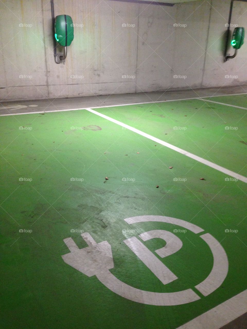 Parkings space reserved for electronic cars in a underground parking garage.