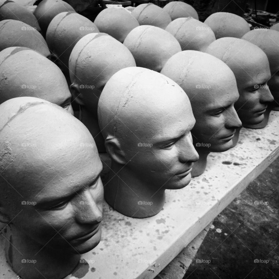 Production photo of slip cast, male heads