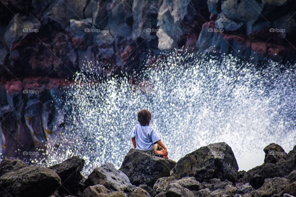 Boy on the lava rocks