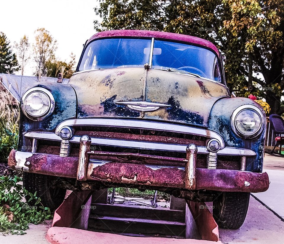 Rusty old car sitting off the road along old Route 66. Did someone say road trip?
