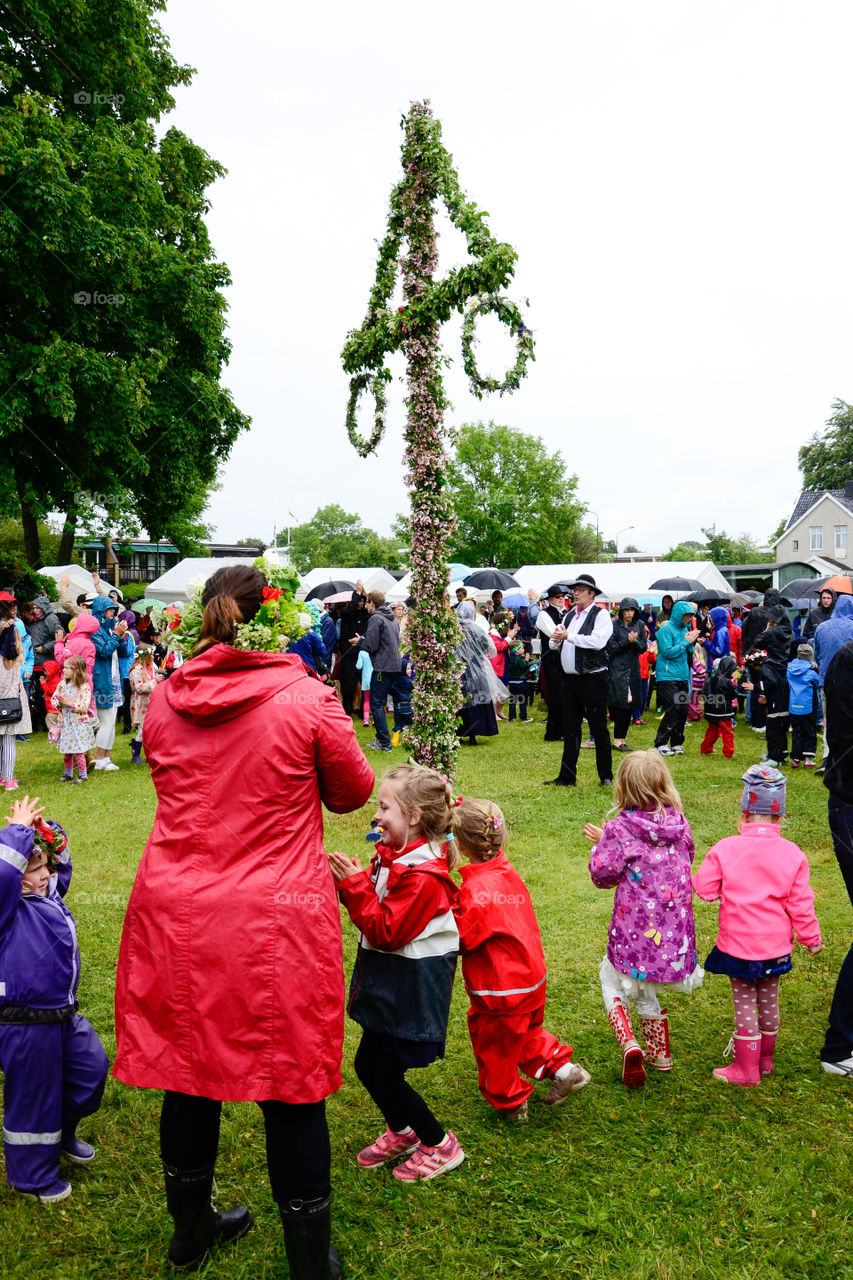 Swedish people is celebrating midsummer in the rain.