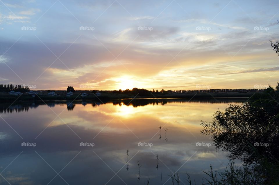 reflection of the setting sun above the lake