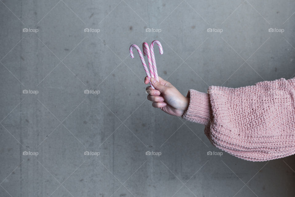 Hand holding Christmas candy 