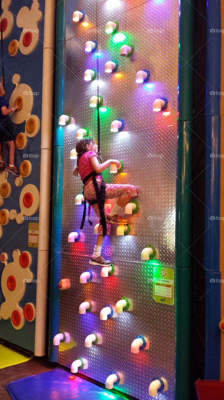 Climbing Wall. Girl climbing wall at Kalahari Indoor theme park in Wisconsin Dells