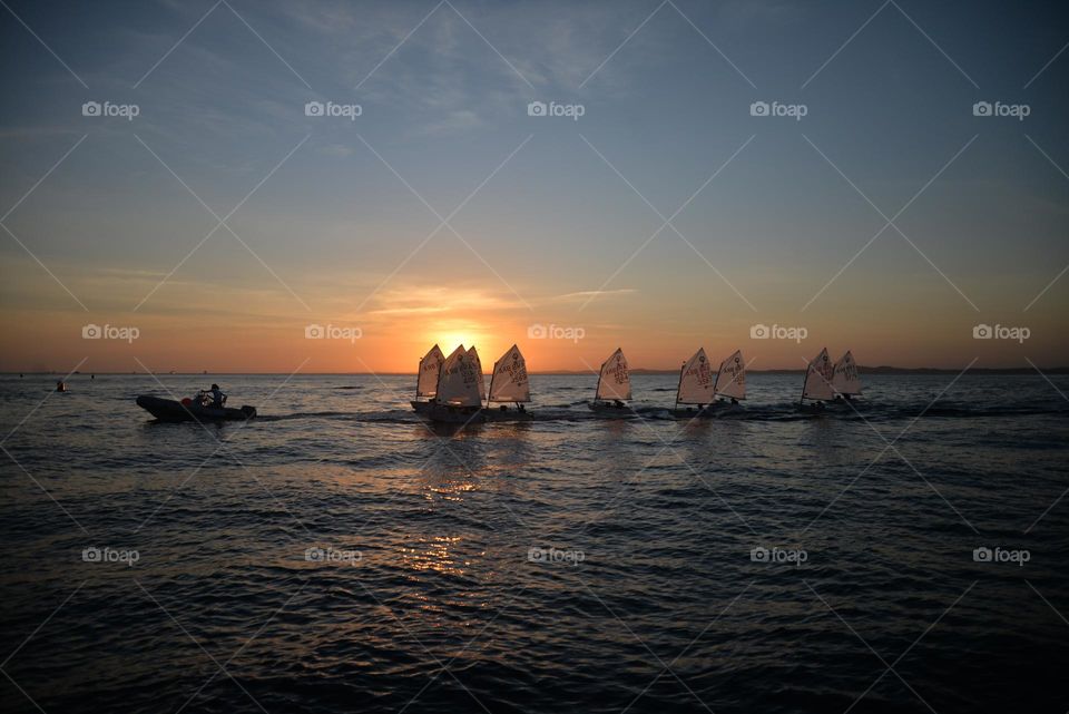 sailing lesson boats for children in a late afternoon in the sea of ​​Bahia, Brazil