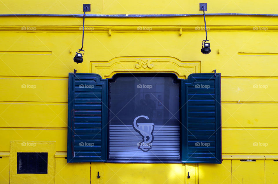 Yellow coloured building exterior with window in Bratislava, Slovakia.