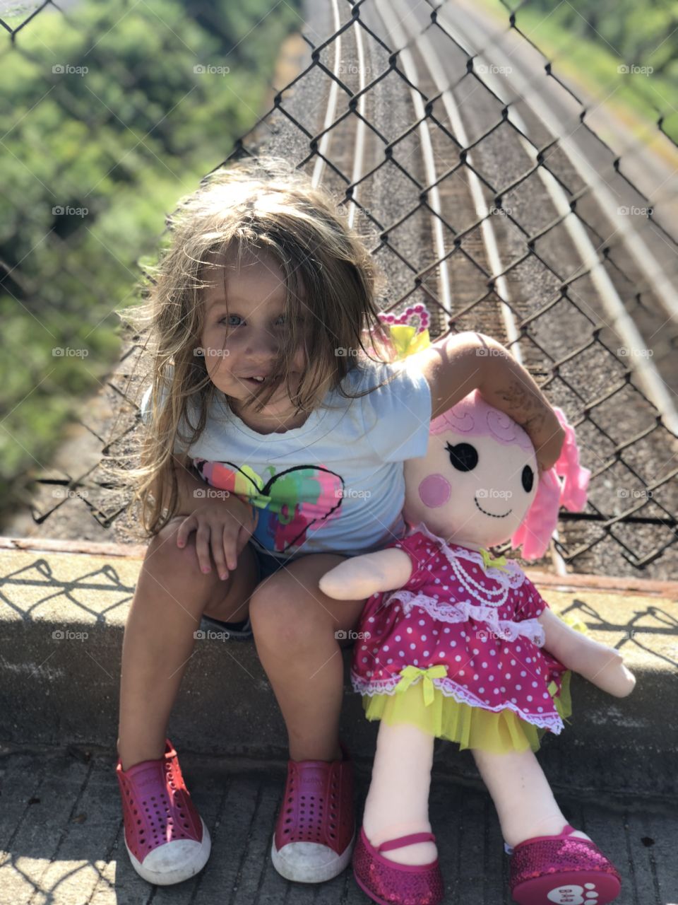 Willow and her dolly watching trains