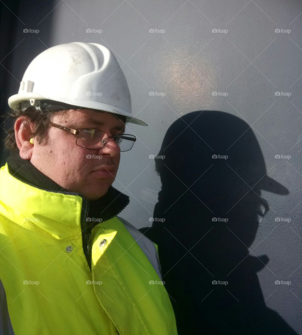 High visibility worker and shadow