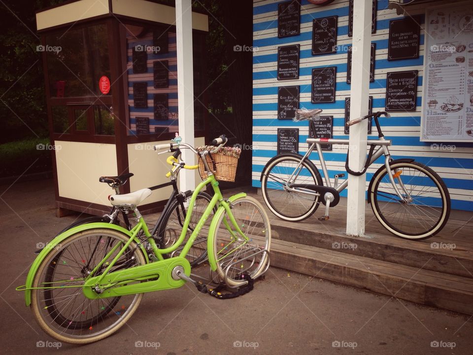 Green electra amsterdam city bicycle and steel colored holland vanmoof bicycle in Gorky park in Moscow, Russia