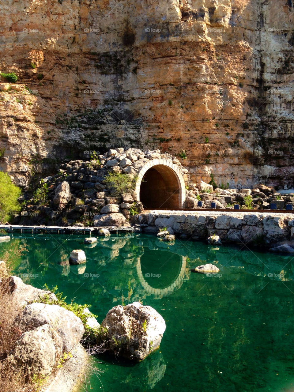 Cave reflecting on lake