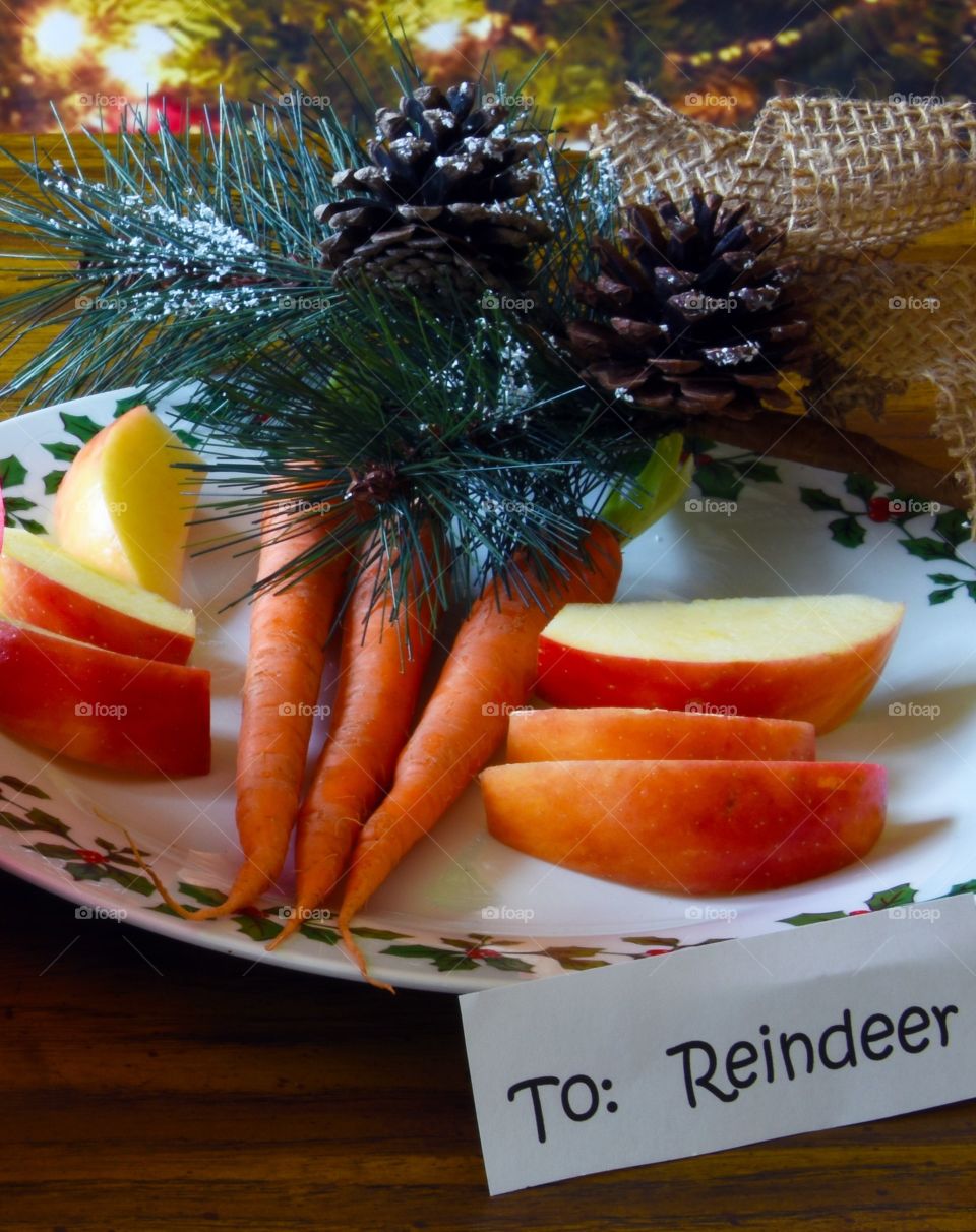 Carrots and apple slices sitting out for Santa’s reindeer 