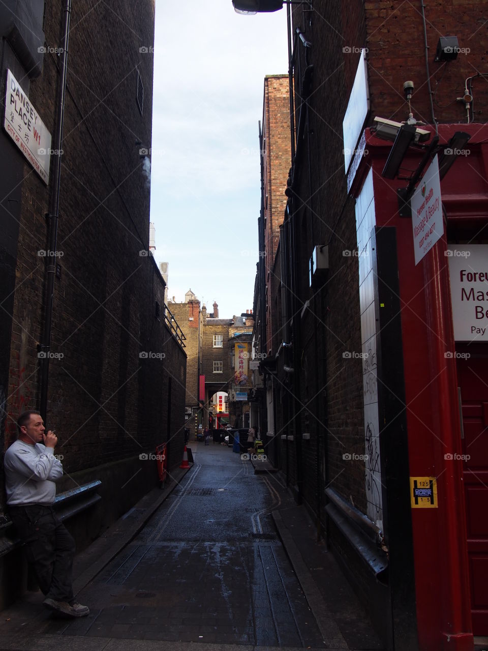 Worker resting in an alleyway