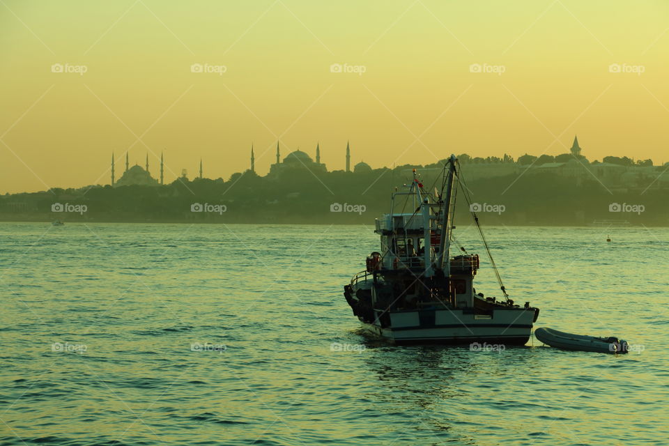 moored in bosphorus. boat moored at golden hour in bosphorus