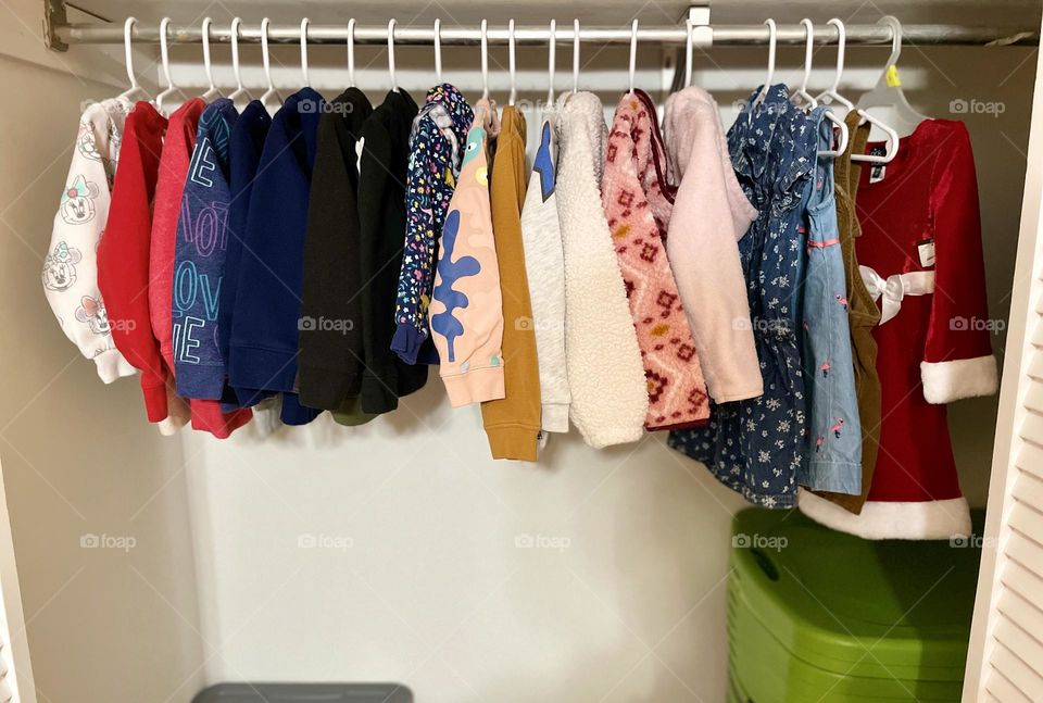 Organizing closets, putting a toddler’s clothes away in a closet, closet organization for your home, making your home tidy and neat, organizing closets for children