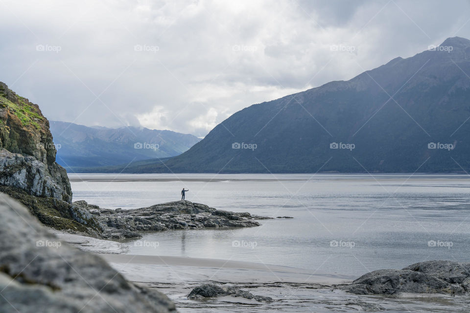 Man takes a selfie picture with an epic landscape vista. 