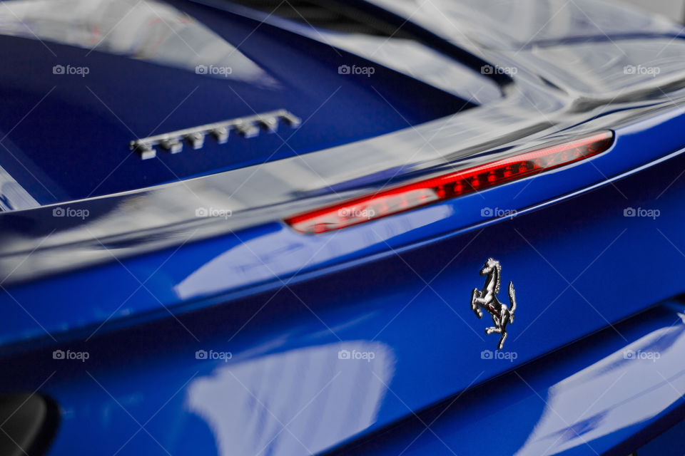 Blue Ferrari 488 spider coupe sports car 3.9 liter V8 twin turbo charged  (F154CB V8) close up back tail light and logo