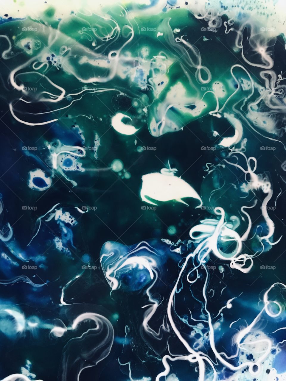 Creating soft, flowing, dynamic, three dimensional abstracts today. Stones, marbles, oil, food dye, glue, water, dish soap and a small paint brush. This one blue and green and painted in lines with white glue. Fun!!!