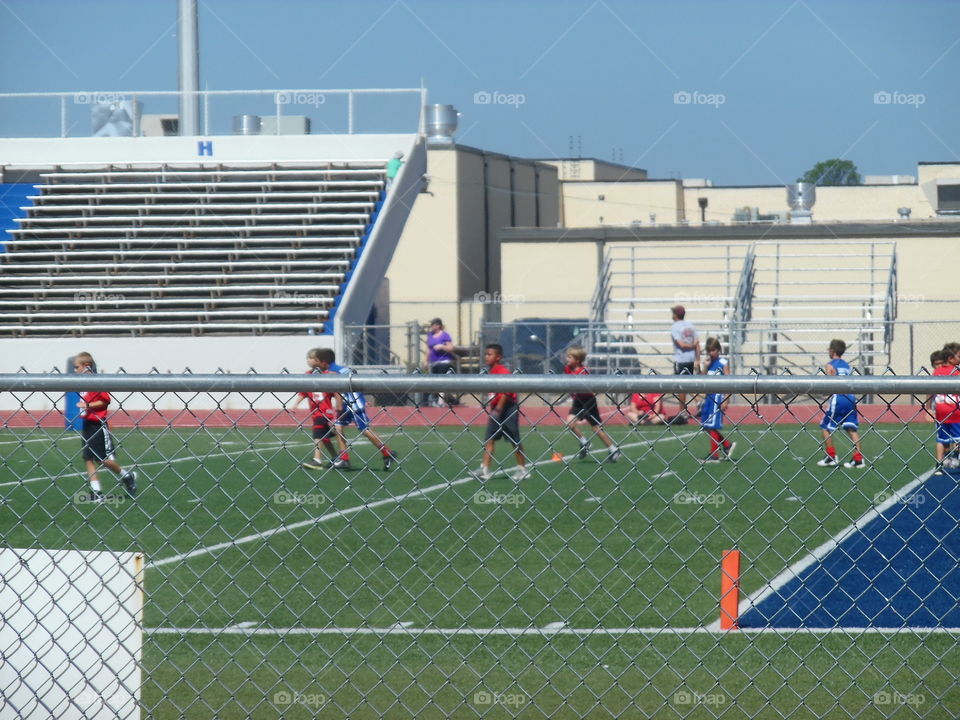 pee wee football 🏈. This is a picture of some football 🏈 players playing in a summer league