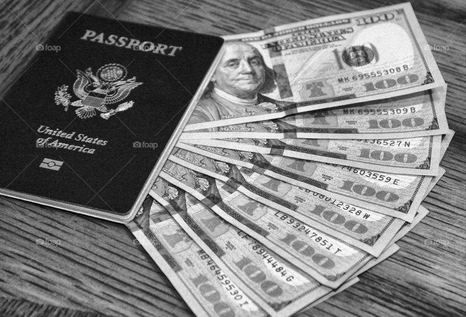 Black & white photography of travel tools, Passport and money.