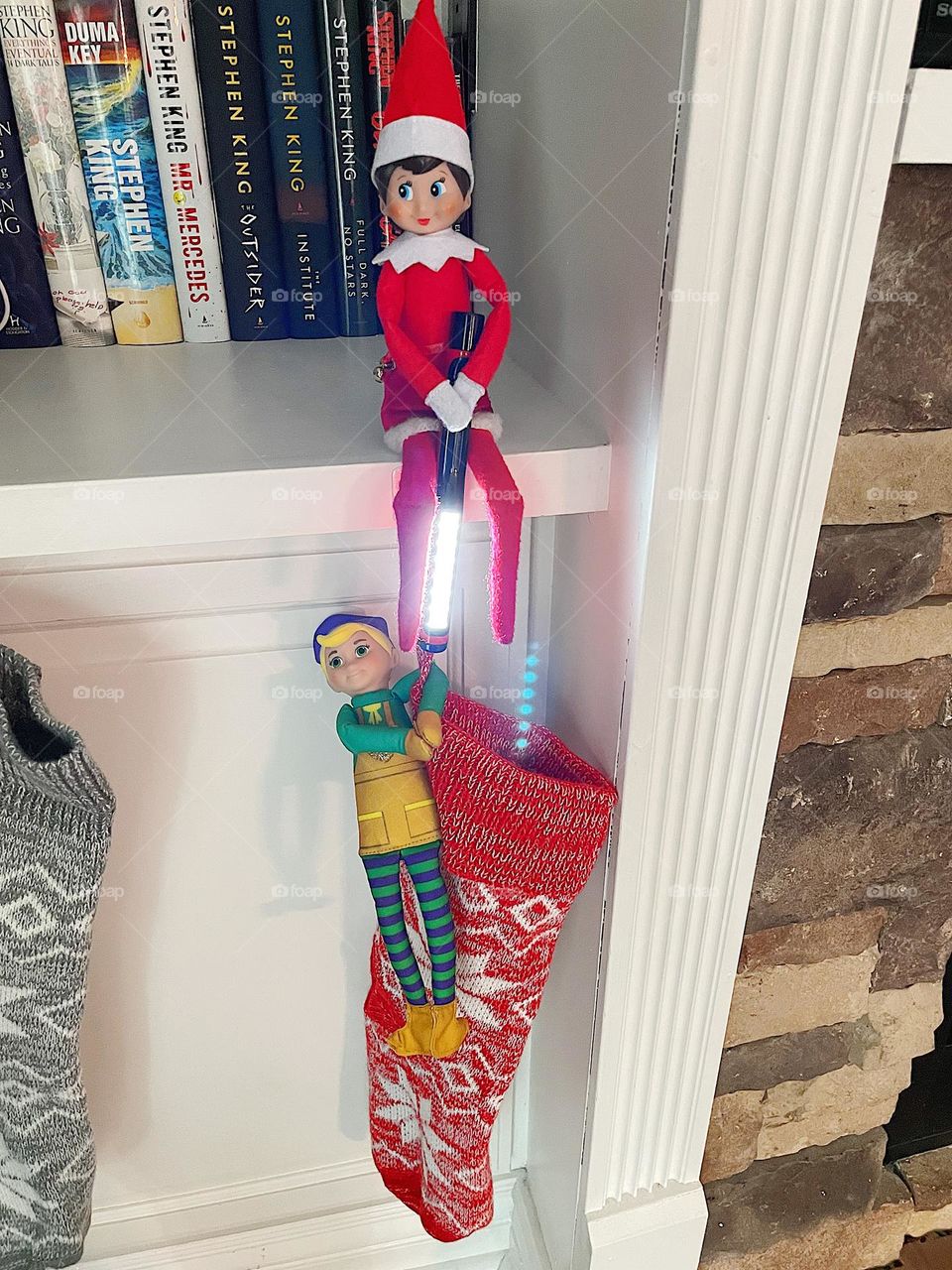 Elf on the shelf antics, elves inspect holiday stockings, stocking stuffers 