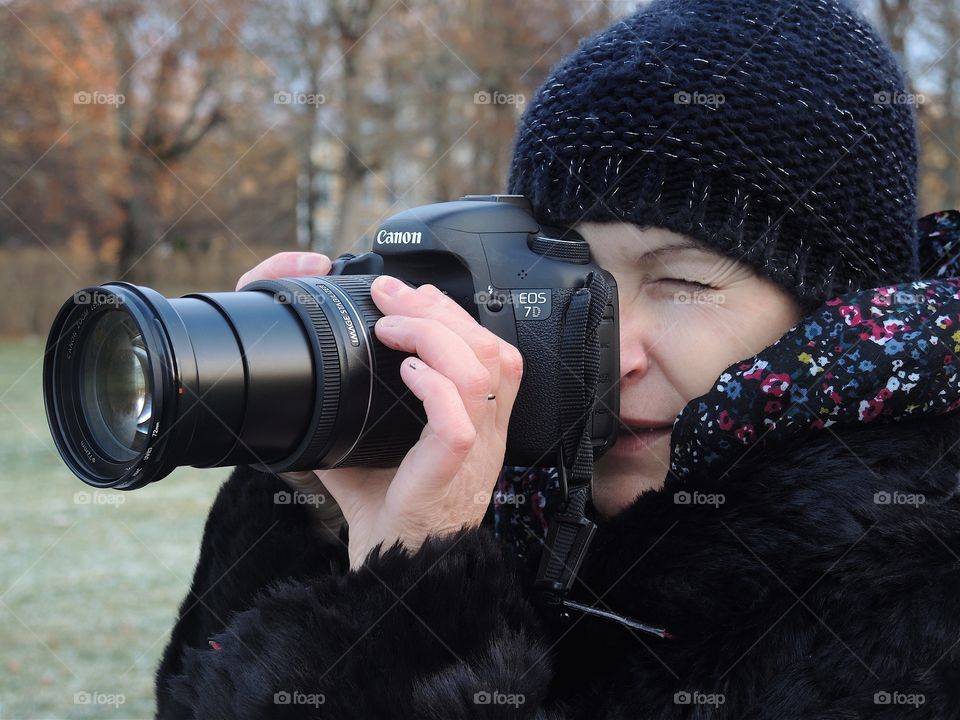 Close-up of a woman taking photograph with camera