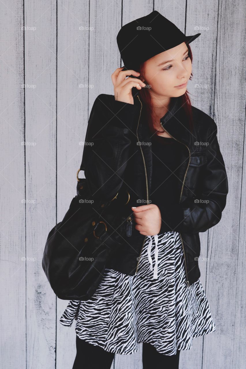 Girl in leather jacket and hat