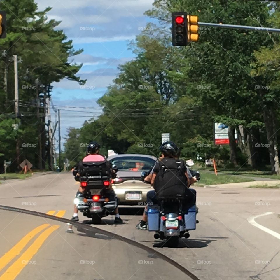 Motorcycles and car stopped at intersection as we travel down road in New England.🏍🏍🏍