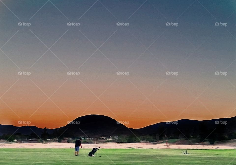 lone golfer. driving range in my nowhere town