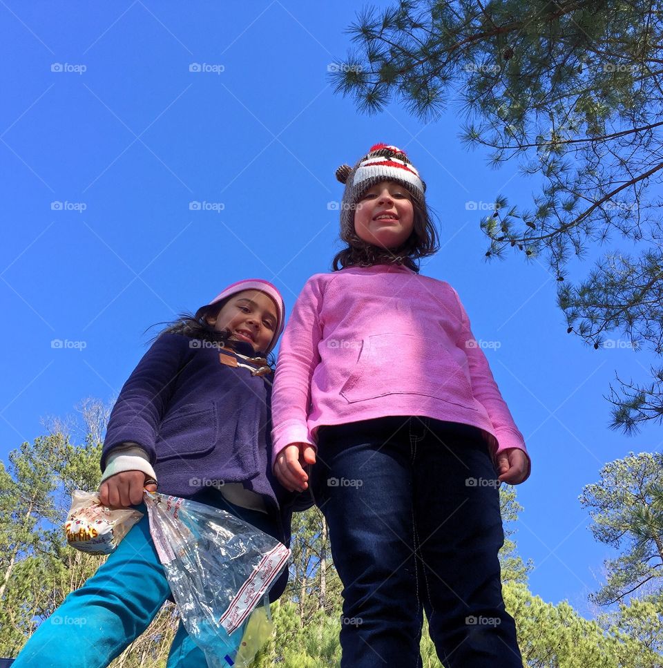 Low angle view of two cute sister