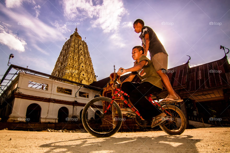 on the bicycle . children in temple 