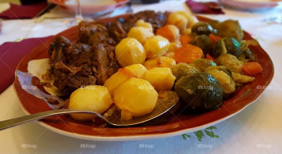 New Year's Day dinner. Roast lamb with potatoes, Brussels sprouts and carrots.