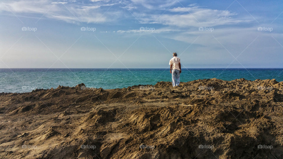 old man looking over the rocks