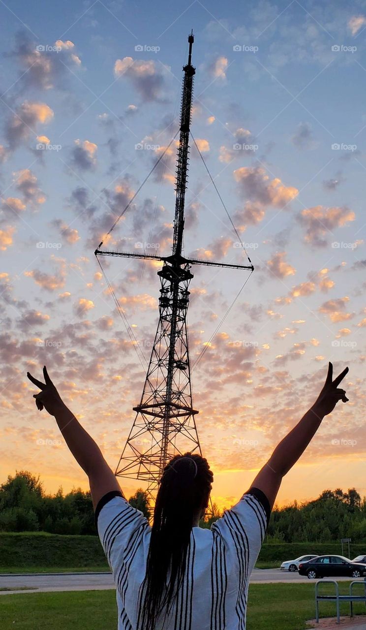 Reaching for the sky! A moment of pure joy and excitement as a person celebrates under the vast, open clouds. A perfect representation of freedom, happiness, and the thrill of life