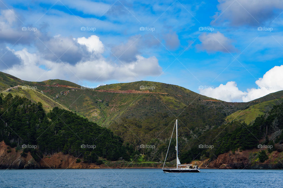 View of sailboat on lake in front of mountain
