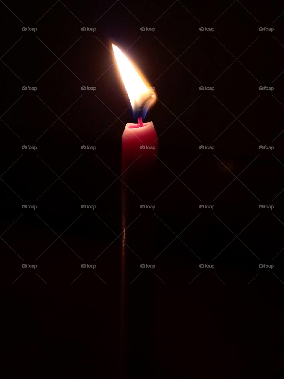 Red candle in darkness