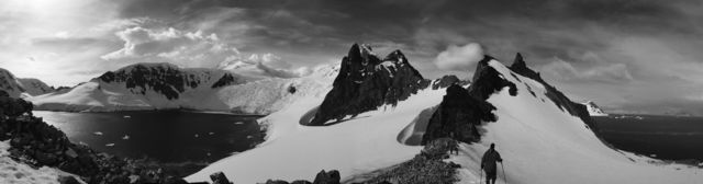 A hiker walks along a ridge of the Antarctic Peninsula in Antarctica. 