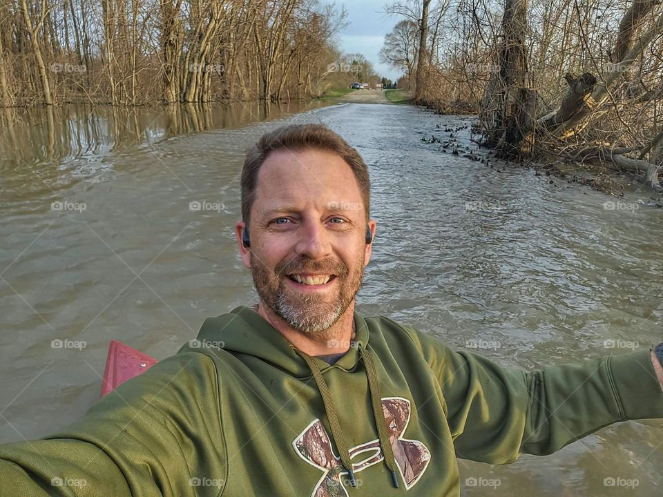 crossing a flooded Road in a kayak